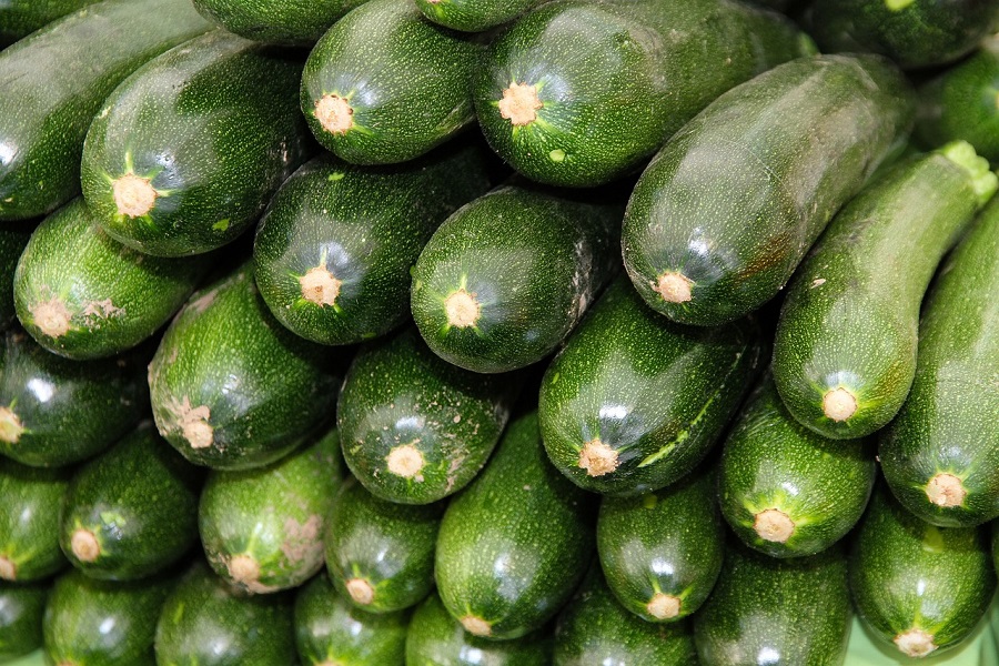 Best Crockpot Zucchini Recipes Close Up of Zucchinis Stacked neatly on Top of Each Other