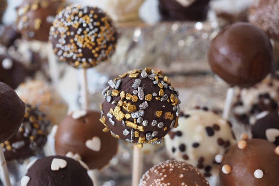 Chocolate Memes Close Up of Chocolate Balls on Sticks Covered in Sprinkles