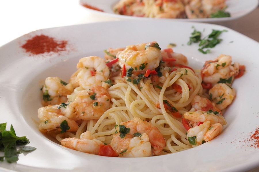 Best Crockpot Shrimp Pasta Recipes Close Up of a Plate of Shrimp and Pasta with Different Seasonings Around the Plate