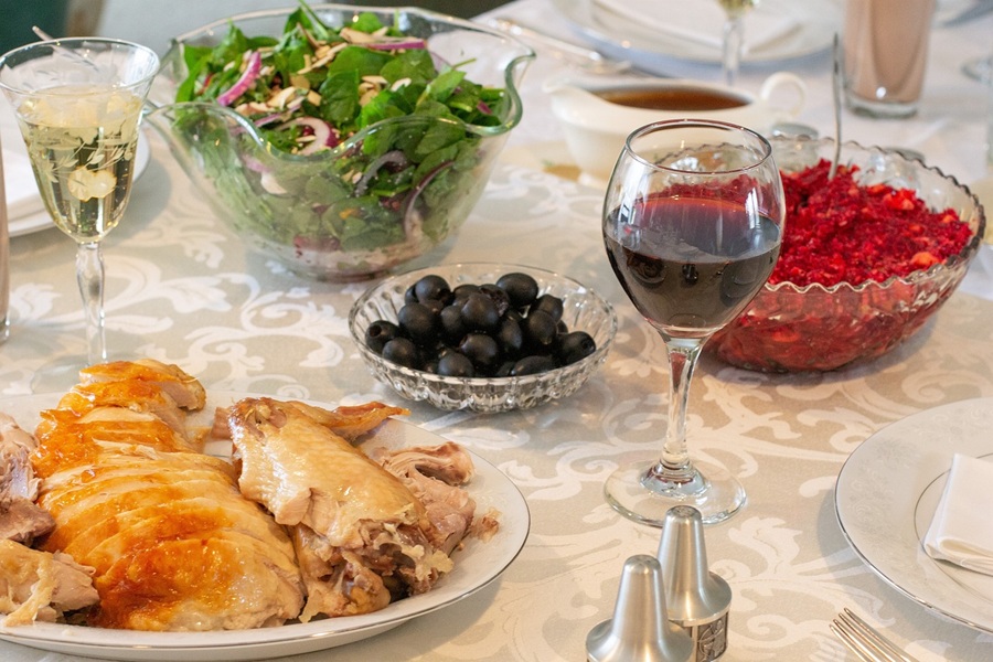 Best Crockpot Thanksgiving Sides Close Up of a Carved Turkey and a Salad on a Table