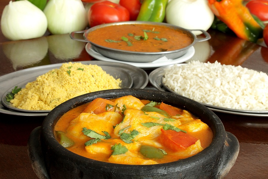 Crockpot Stews with Chicken a Small Stew Bowl Filled with Stew Next to Plates of Rice and Sauces