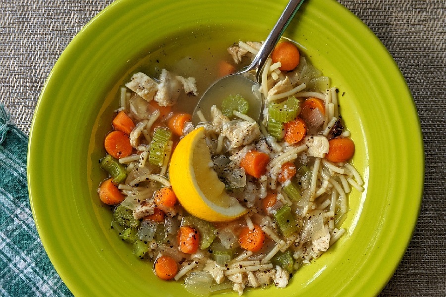Easy Slow Cooker Soups with Chicken Close Up of a Green Bowl Filled with Chicken Noodle Soup