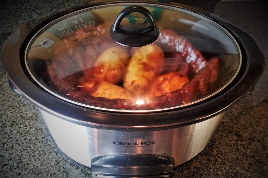 Funny Slow Cooker Memes Close Up of a Crockpot with a Glass Lid On and Meat and Potatoes Cooking Inside