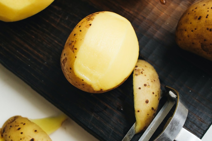 Hashbrown Hamburger Casserole Recipes Close Up of a Potato Being Peeled