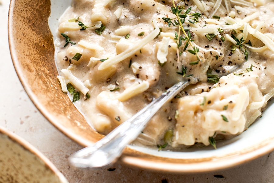 Easy Leftover Turkey and Noodles Recipe Close Up of a Bowl of Casserole with a Silver Spoon Sticking Out