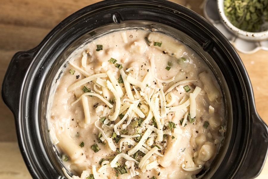 Easy Leftover Turkey and Noodles Recipe Overhead View of a Crockpot with The Casserole Inside Topped with Cheese