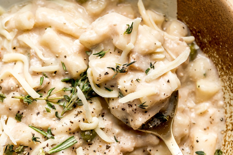 Easy Leftover Turkey and Noodles Recipe Close Up of a Silver Spoon in a Bowl of Turkey Casserole