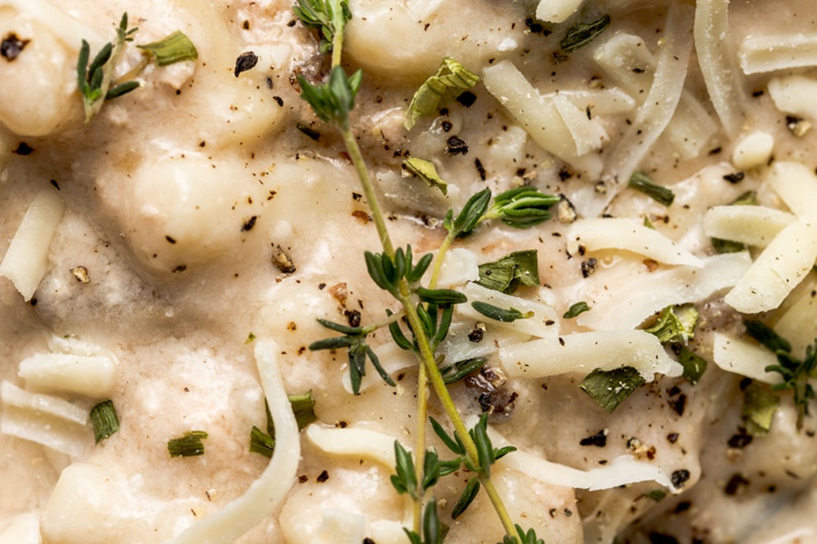 Easy Leftover Turkey and Noodles Recipe Close Up of a Sprig of Thyme On Top of a Bowl of Casserole