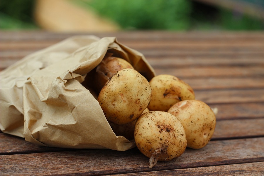 Hashbrown Hamburger Casserole Recipes a Paper Sack of Potatoes Spilling Out onto a Wooden Table