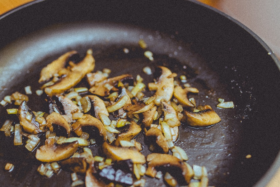 Mushroom Caps vs Stems Cooking Tips Close Up of Mushrooms in a Frying Pan