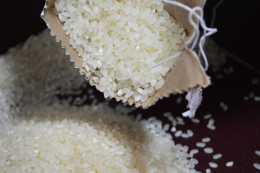 Instant Pot Rice Too Sticky a Bag of White Rice Spilling Over Onto a Dark Surface