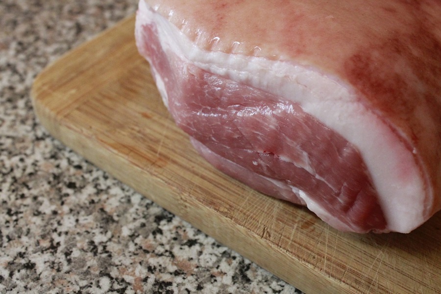 Can I Put a Frozen Pork Roast in the Crockpot Close Up of Raw Pork on a Cutting Board