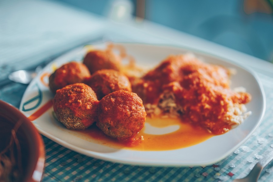 How to Cook Frozen Uncooked Meatballs Close Up of a Plate of Meatballs in a Marinara Sauce