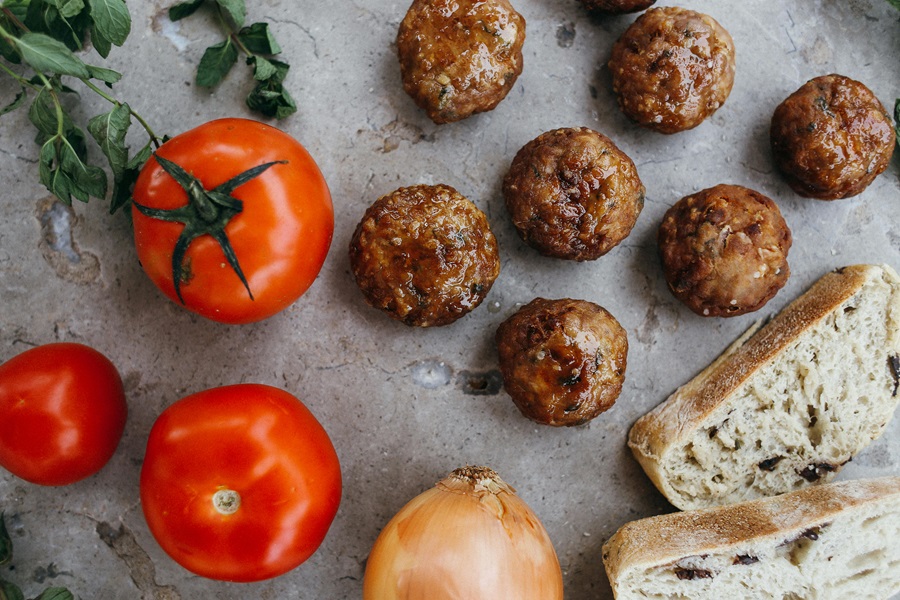 How to Cook Frozen Uncooked Meatballs Meatballs, Tomatoes, and Sourdough Bread on a Metal Surface