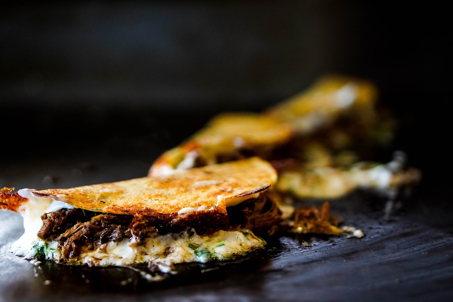 Mexican Barbacoa Recipe Ideas Two Tacos on a Griddle Cooking with Cheese Melting on Top