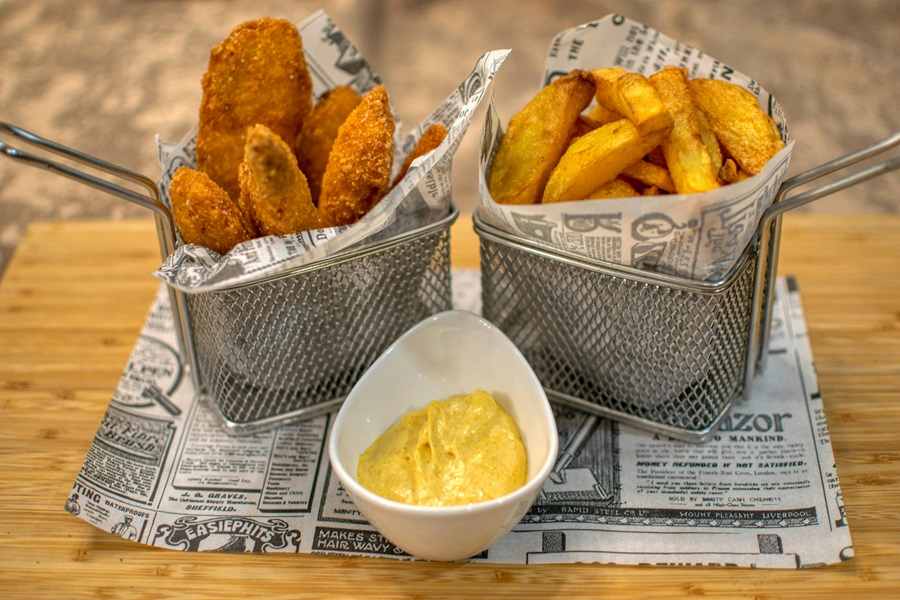 Easy and Cheap Air Fryer Recipes a Basket of Chicken Strips and a Basket of Fries with a Small Dish of Mustard Between Them