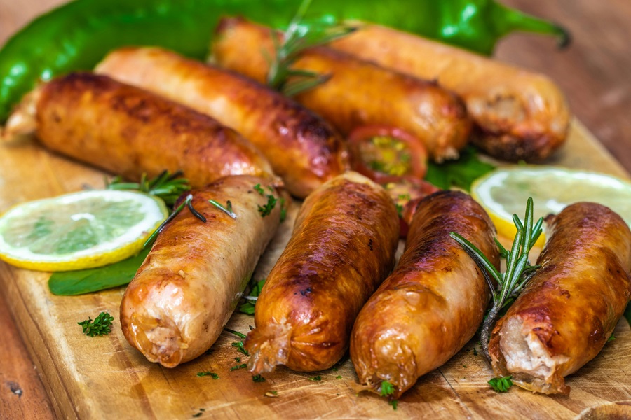 Easy and Cheap Air Fryer Recipes Cooked Sausages on a Cutting Board