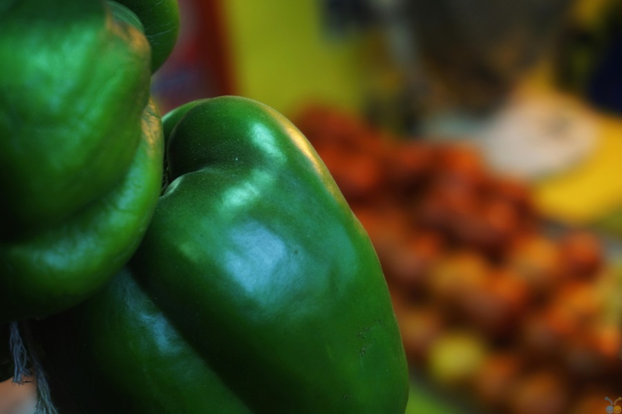 Best Stuffed Bell Pepper with Ground Beef Recipes Close Up of Green Bell Peppers with Other Produce Blurred in the Background