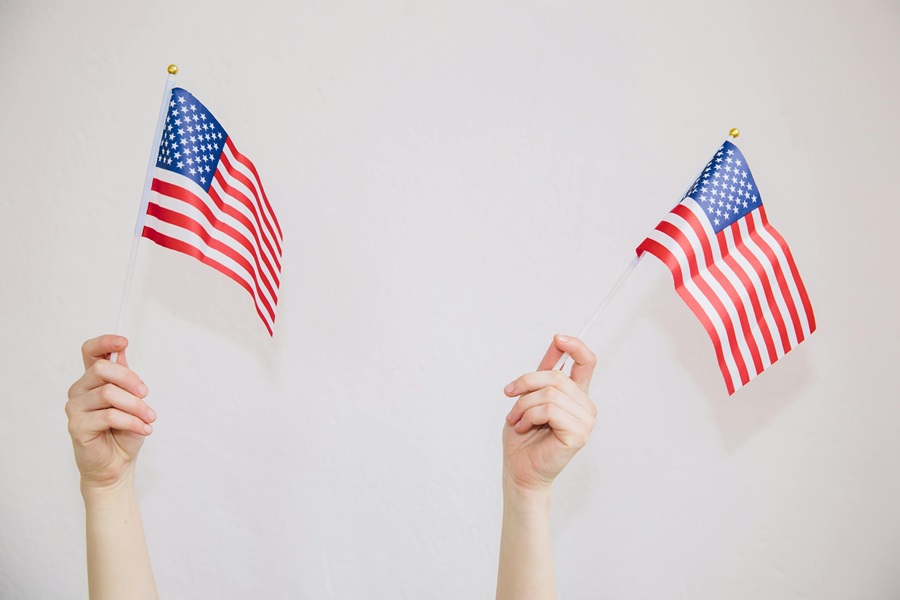 Easy Patriotic Food Appetizers for a Party Close Up of Two Hands Waving American Flags