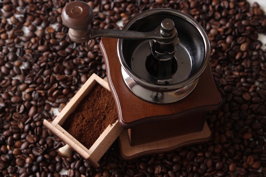 What Dissolves Coffee Grounds a Coffee Grinder Surrounded by Coffee Beans