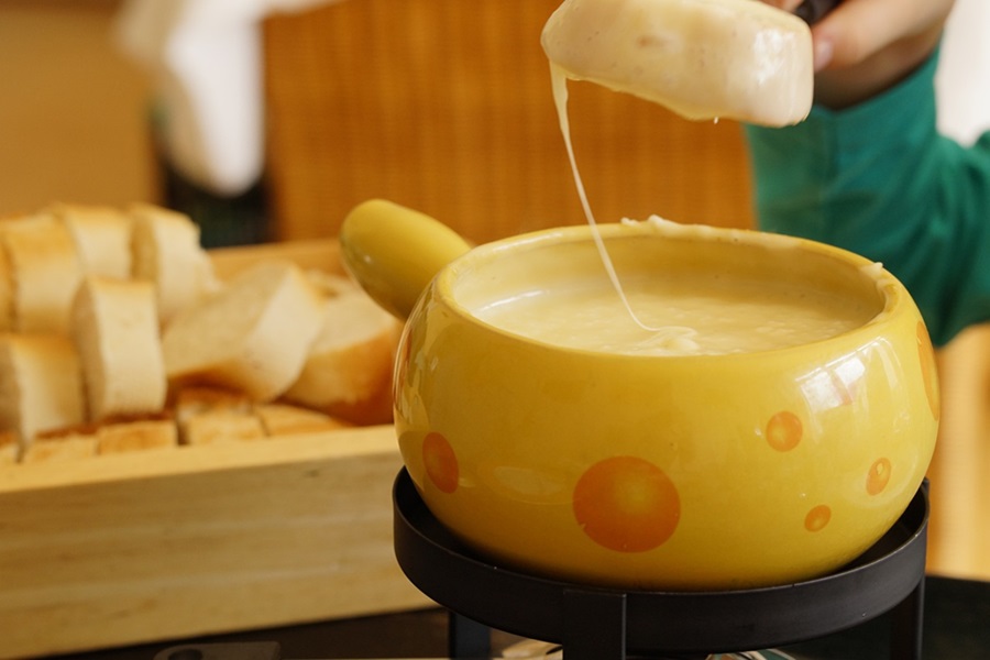 Recipes with Queso Dip Close Up of a Fondue Pot Filled with Cheese