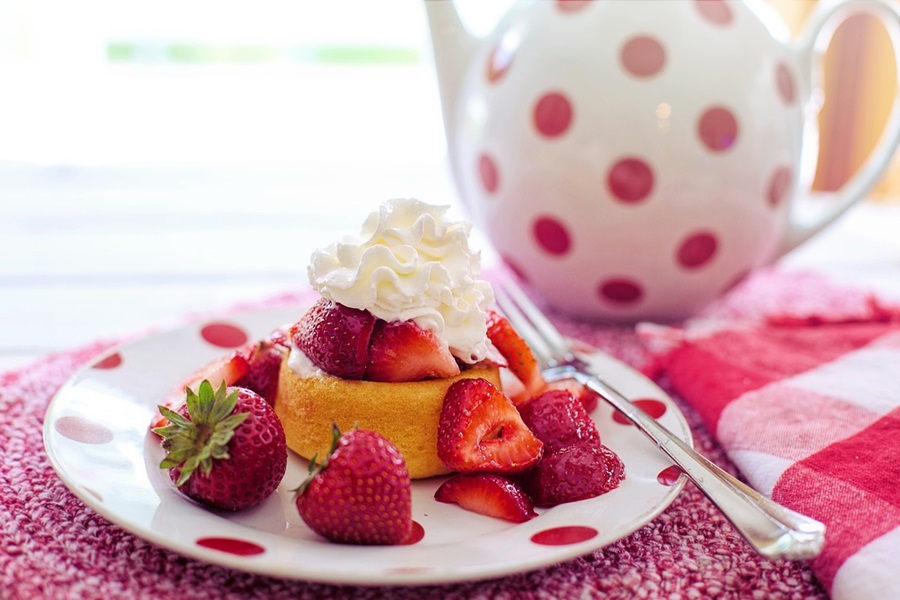 Strawberry Shortcake Recipes a Strawberry Shortcake on a Plate with Fresh Strawberries and a Teapot in the Background