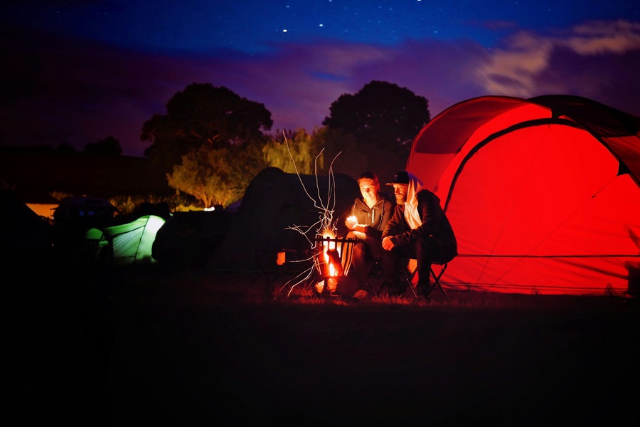 Cast Iron Cooking Recipes A Campsite at Night with a Glowing Tent Lit Up From Inside and a Fire Outside