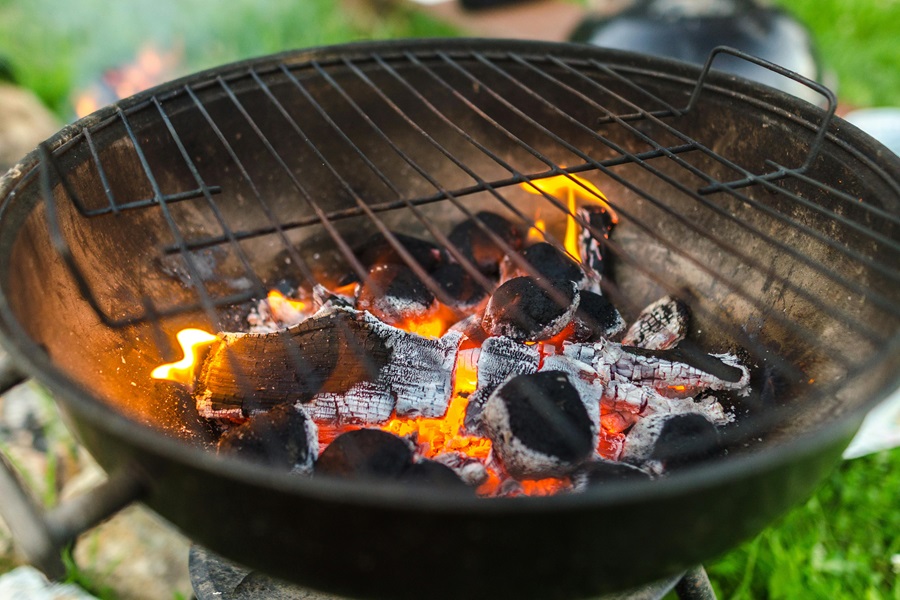 Summer Dinner Recipes for the Grill Close Up of a Grill with Burning Charcoals