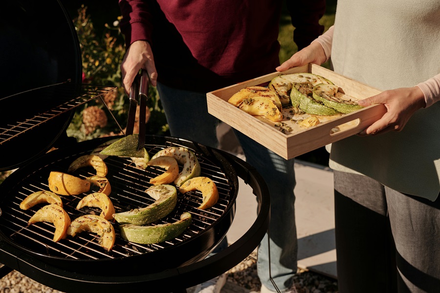 Summer Dinner Recipes for the Grill Two People Working Together to Grill Veggies and Fruit Outside