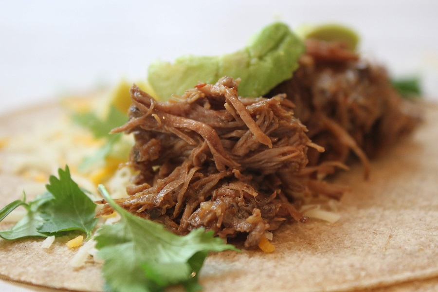 Easy Crockpot Beef Barbacoa Close Up of Barbacoa on a Corn Tortilla with Cilantro