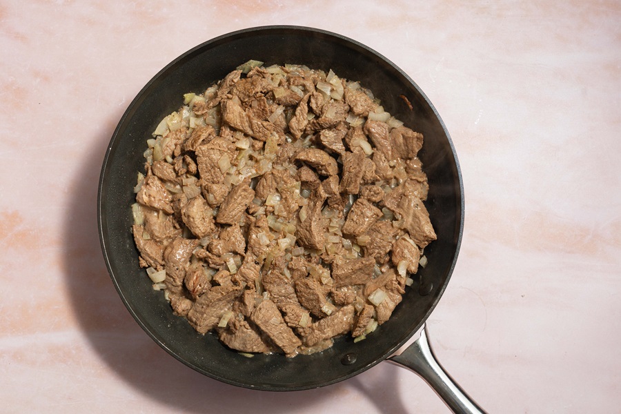 Easy Crockpot Beef Barbacoa a Skillet with Cooked Beef Inside