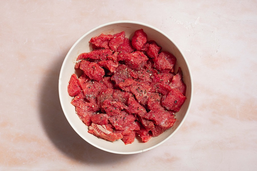 Easy Crockpot Beef Barbacoa a Bowl of Raw Beef with Salt and Pepper