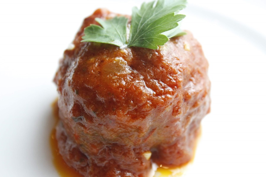 Easy Crockpot Meatballs Dinner Recipe Close Up of a Single Italian Meatball on a White Plate