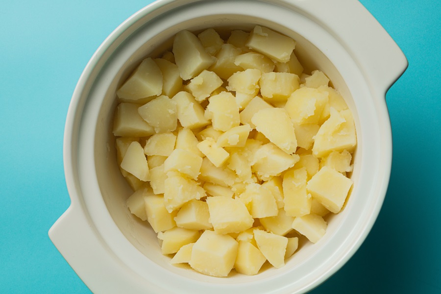 Easy Twice-Baked Mashed Potatoes Recipe Close Up of Cubed, Cooked Potatoes in a Baking Dish