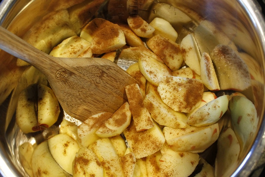 Faster than Stovetop Instant Pot Cinnamon Apples Recipe Close Up of Ingredients in an Instant Pot with a Wooden Spatula