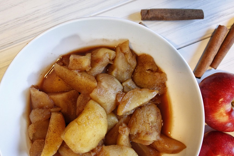 Faster than Stovetop Instant Pot Cinnamon Apples Recipe Close Up of a White Bowl Filled with Cinnamon Apples