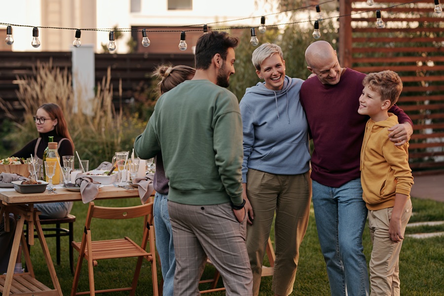Vegan Thanksgiving Appetizers a Family Enjoying a Conversation Near a Thanksgiving Table Outdoors