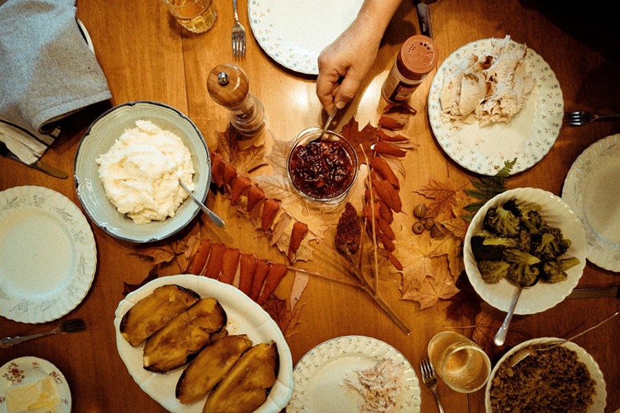 Vegan Thanksgiving Appetizers Overhead View of a Thanksgiving Table with Breads and Salads
