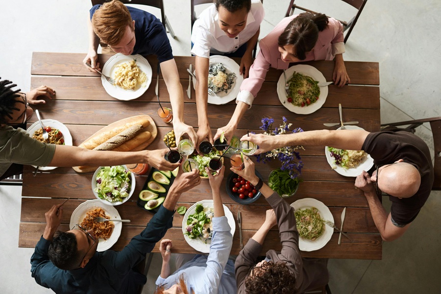 Southern Thanksgiving Recipes Overhead View of a Family Toasting Above a Thanksgiving Dinner