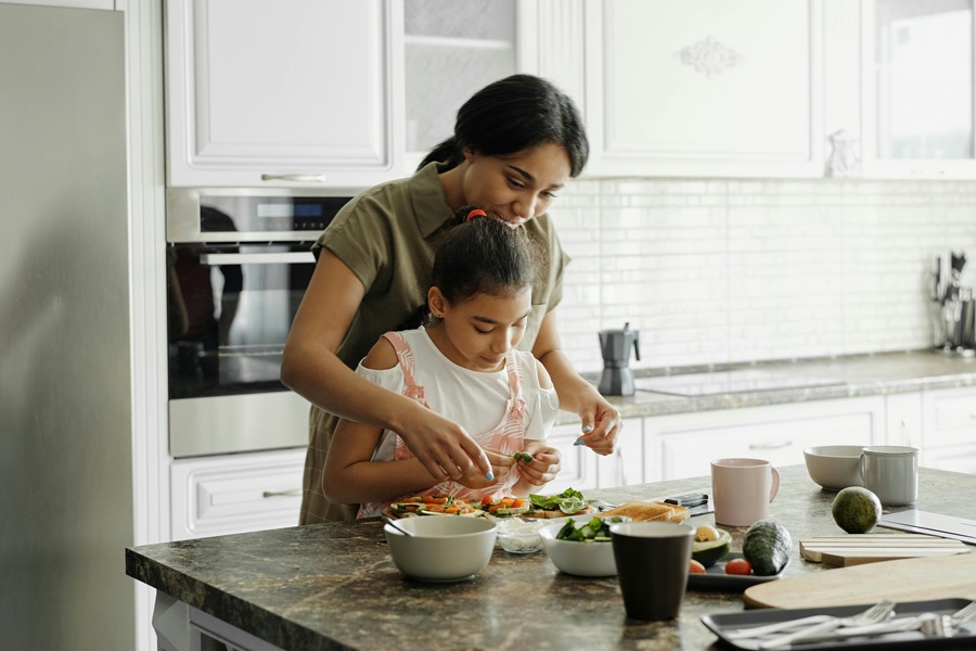Vegan Thanksgiving Appetizers a Mom and Daughter Cooking Together in a Kitchen