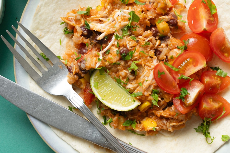 Easy Chicken Tacos in the Slow Cooker Recipe Close Up of Chicken on Tortillas with a Fork and a Knife