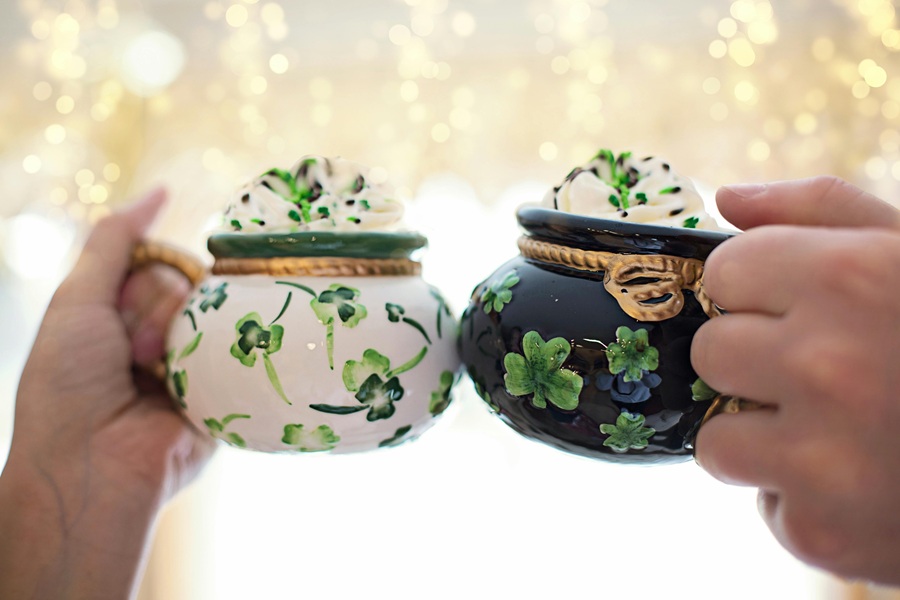 St. Patrick's Day Food Snack Ideas Two Coffee Mugs That Look Like Pots of Gold with Whipped Cream Coming From the Top of Each Being Clinked Together