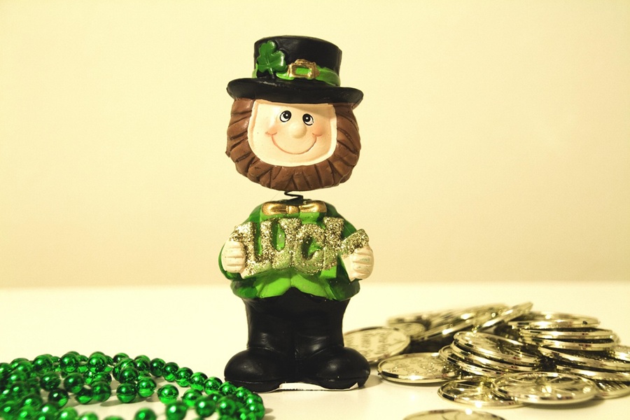 St. Patrick's Day Food Snack Ideas a Small Leprechaun Toy Next to Green Beads and a Small Pile of Fake Gold Coins