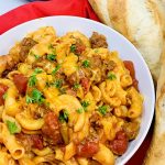 Easy Goulash in the Instant Pot a Plate of Goulash Next to Two Loaves of French Bread