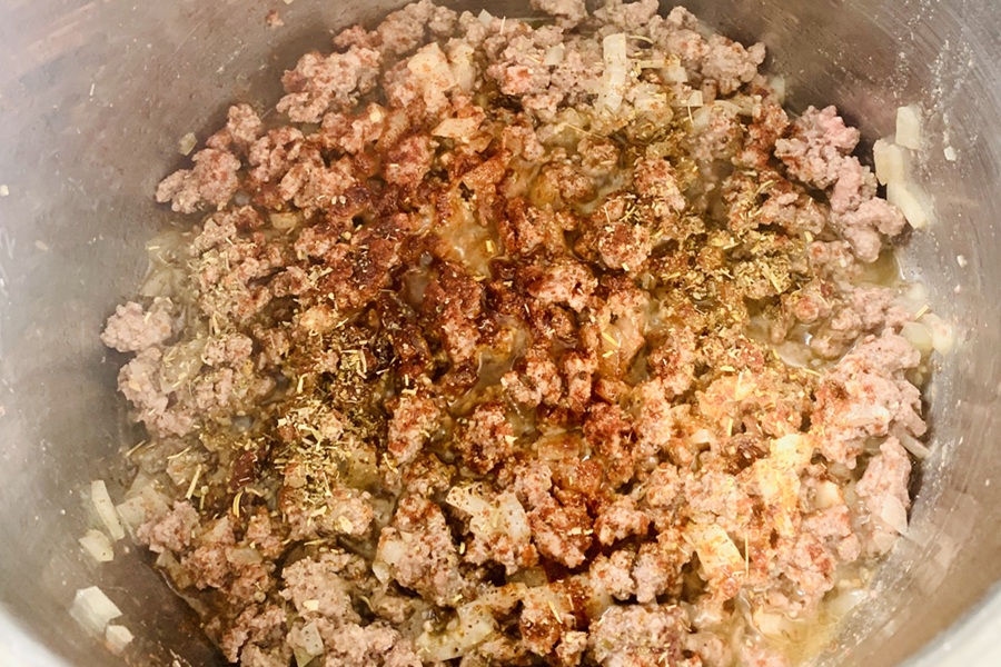 Easy Goulash in the Instant Pot Close Up of Ground Beef in an Instant Pot with Seasonings On Top