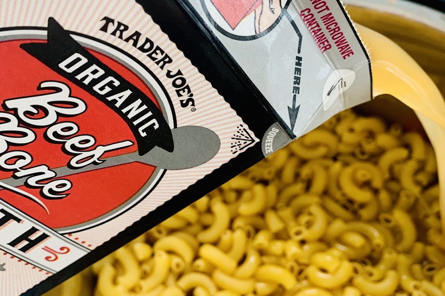 Easy Goulash in the Instant Pot Beef Broth Being Poured Into an Instant Pot with Macaroni Noodles