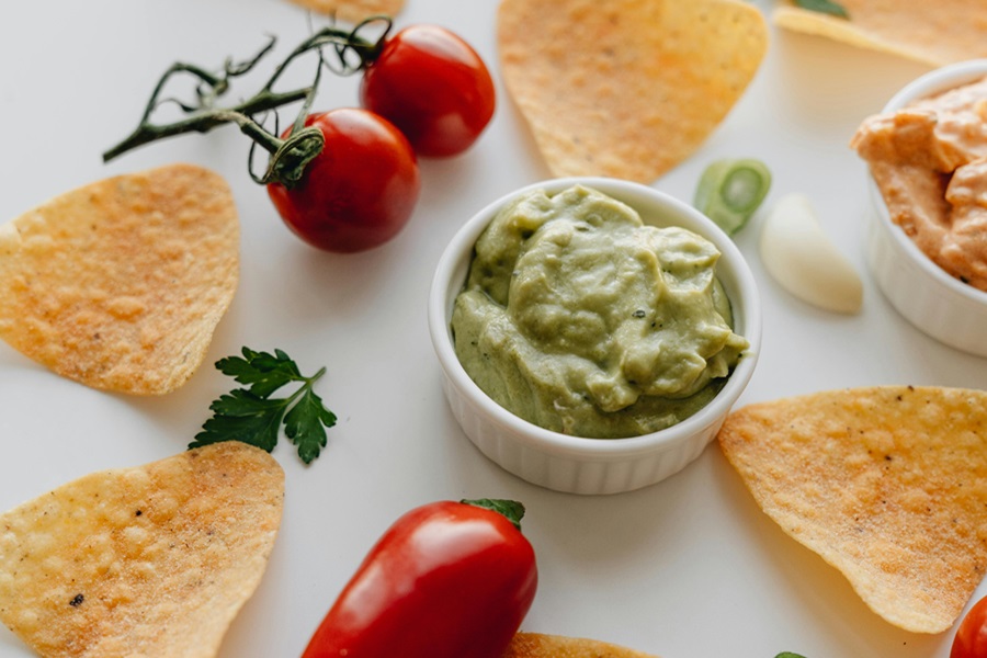 Chicken Tacos Crockpot Recipe a Small Ramekin of Guacamole with Tortilla Chips Scattered Around