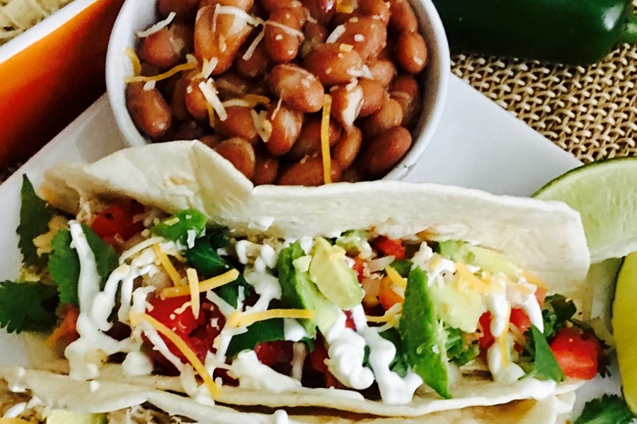 Chicken Tacos Crockpot Recipe Close Up of Tacos and a Side of Beans on a Plate
