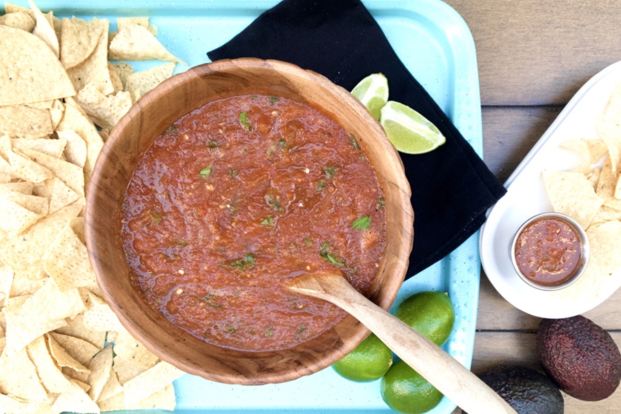 Salsa without Onions Recipe a Bowl of Salsa with a Wooden Spoon Inside Next to Chips and Limes