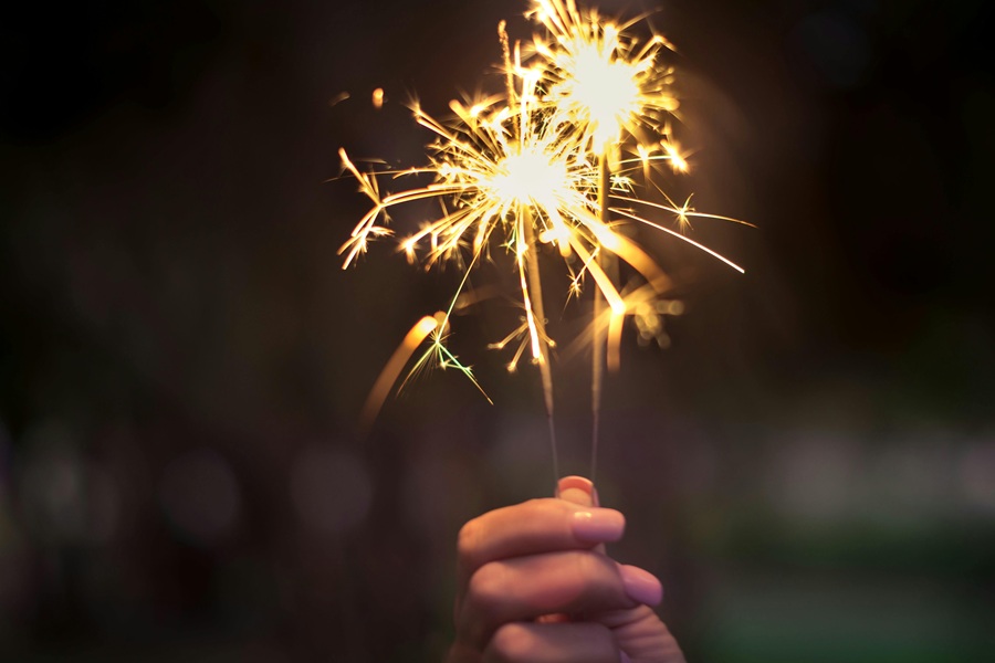 4th of July Cookies Close Up of a Sparkler in a Woman's Hand
